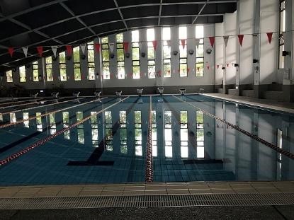 A heat pump system (consist of 2 heat pump units, middle) used to warm up the swimming pool (left) year round at Zhiben campus. The water temperature dashboard of each unit (right). (Taitung University) 